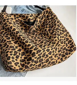Close-up of leopard print canvas tote bag showing interior lining and durable strap