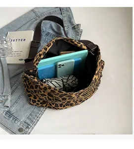 Spacious leopard print canvas tote interior holding a tablet, phone and daily essentials