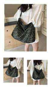 Detail view of leopard print canvas tote bag with wide shoulder strap and large capacity