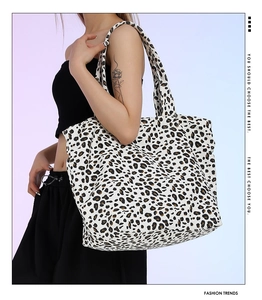 Lifestyle view of a large leopard print canvas tote bag styled with casual outfit