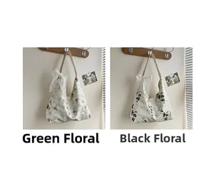 Détail de sacs fourre-tout en toile à fleurs avec motifs vert et noir et nœuds en dentelle