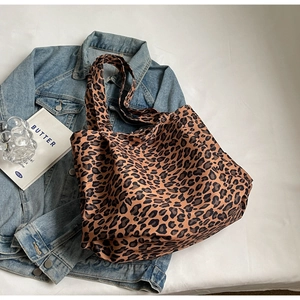 Detail view of the soft leopard print fabric texture on a large capacity tote bag