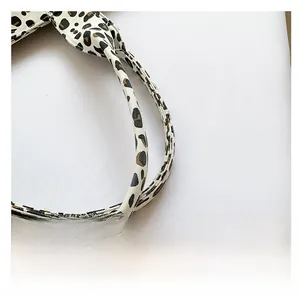 Close-up of leopard print shoulder strap on a retro canvas bag with fine stitching