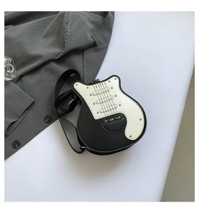 Detail of guitar-shaped shoulder bag featuring black and white PU leather and silver rivets