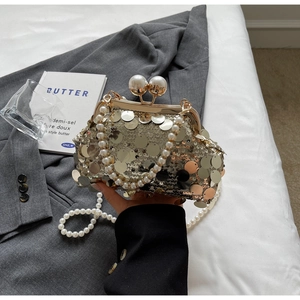 Detail of champagne gold sequin evening bag with large pearl clasp and handle chain
