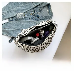 Top view of large leopard print tote bag interior showing vast storage capacity and zipper