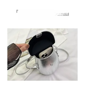 Silver saddle bag interior showing magnetic clasp and capacity for a smartphone