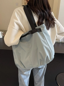 Light blue large capacity shoulder bag with minimalist design and wide nylon strap