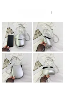 Detailed four-sided view of a silver matte saddle-style mini phone crossbody bag
