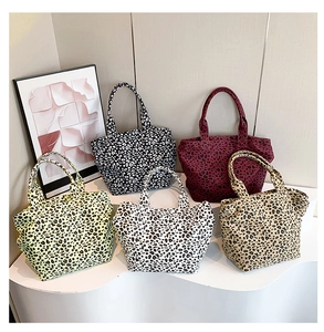Collection of five leopard print canvas tote bags in various stylish colors shown together
