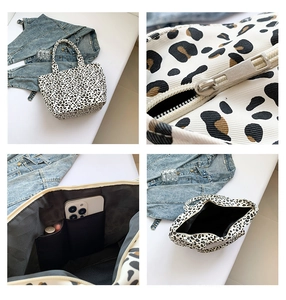 Detail view of leopard print tote bag with smooth zipper and interior phone pockets
