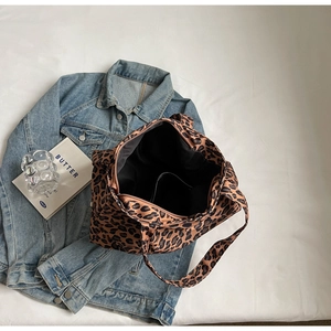 Close-up of leopard print tote bag with black fabric lining and durable zipper detail
