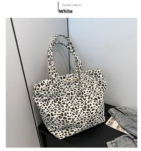 Detailed view of leopard print canvas tote bag on a minimalist display setting