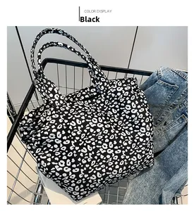 Detail of a large leopard print canvas tote bag inside a silver shopping cart