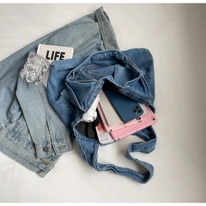 Detail of blue denim tote bag with high capacity storage and pocket stitching style