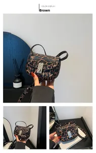 Detail of leopard print handbag with silver embossed buckle and brown faux leather texture