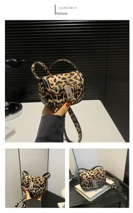 Close-up of leopard print saddle bag showing metal buckle and adjustable strap