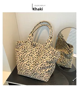 Detail view of khaki leopard print tote bag with spacious interior on a display stand
