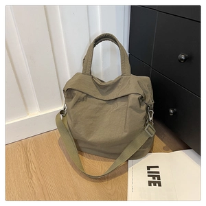 Détail du sac cabas vert olive en nylon froissé avec bandoulière réglable et poignées