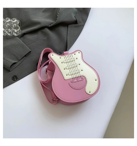 Detail of guitar shaped crossbody bag in pink and cream with metallic stud accents