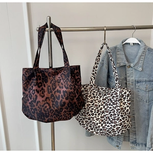 Detailed comparison of two leopard print tote bags in dark brown and beige patterns