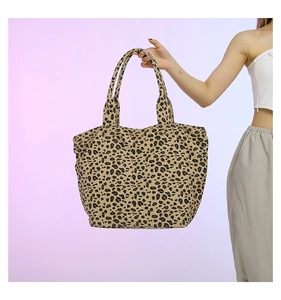 Detail showing high-quality leopard print texture on a large canvas tote bag