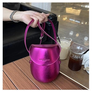 Detailed close-up of metallic magenta saddle bag with embossed FASHION & BAGS LEATHER logo
