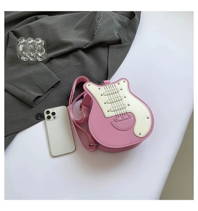Detail view of the pink guitar-shaped crossbody bag with metallic rivets and stitching