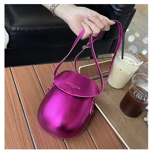 Detail view of mini metallic purple saddle bag on a cafe table with premium finish