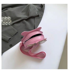 Detail view of pink cat-ear crossbody bag showing internal storage and metal zipper