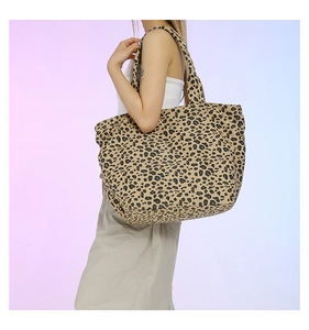 Detailed view of casual leopard print tote bag with wide shoulder strap on a model