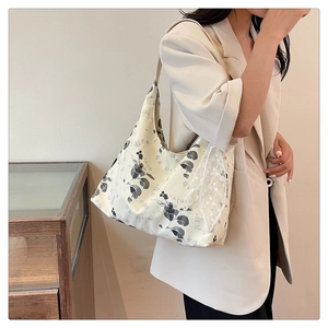 Détail montrant la bordure en dentelle blanche sur le sac hobo en toile à fleurs