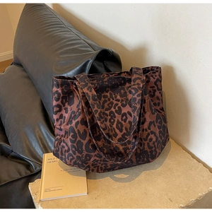 Close-up of leopard print canvas tote bag on a stone surface with stylish interior background