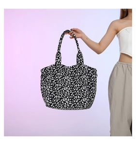 Detail view of large leopard print tote bag featuring reinforced nylon shoulder straps