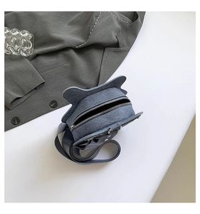 Top view of creative cat-ear shaped crossbody bag in blue-grey with wide fabric strap