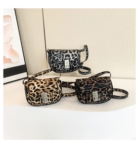 Detailed close-up of leopard print saddle bags in three colors with metallic buckles