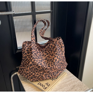 Detail of leopard print tote bag with canvas texture on a stylish marble background
