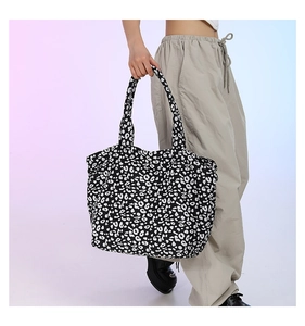 Detail of a large canvas tote bag featuring classic black and white leopard animal print