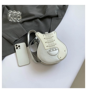 Detail view of guitar shaped crossbody bag with metallic silver accents and stylish rivets