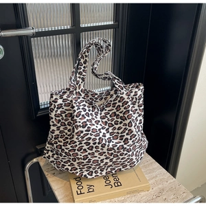 Close-up detail of leopard print tote bag fabric with thick canvas and sturdy handle straps