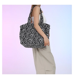 Detail view of large capacity canvas tote bag with black and white leopard print and soft straps