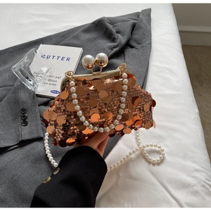 Detailed shot of bronze sequin evening bag with large pearl clasp and pearl chain strap