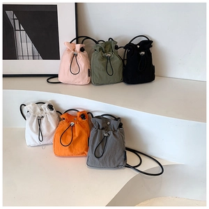 Close-up of lightweight nylon bucket bags in six colors with stylish drawstring closures