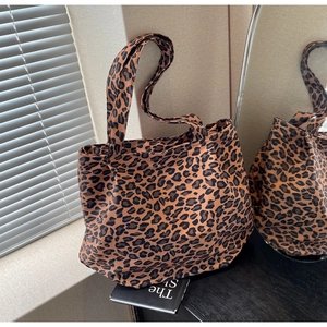 Detail view of large leopard print tote bag with soft canvas texture and durable dual straps