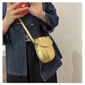 Golden candy color saddle bag crossbody phone purse shown as a stylish model display