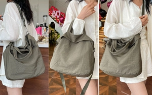 Détail du sac fourre-tout en toile vert armée avec bretelles réglables et texture souple
