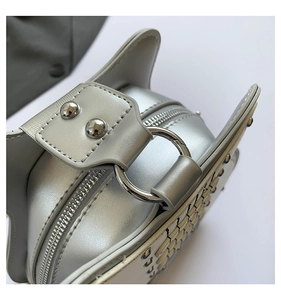 Close-up of silver guitar-shaped shoulder bag showing metal zipper and rivet details