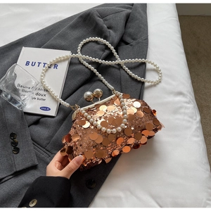 Detail of rose gold sequin evening bag with dual pearl clasp and long pearl strap