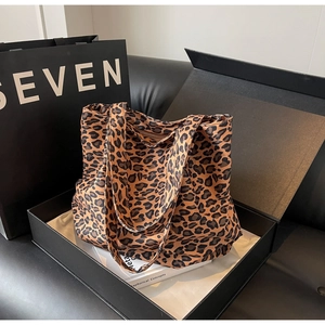 Detail of leopard print tote bag with soft fabric texture and luxury prop packaging