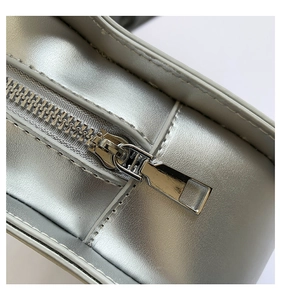 Macro shot of silver textured leather finish and high-quality metallic zipper detail